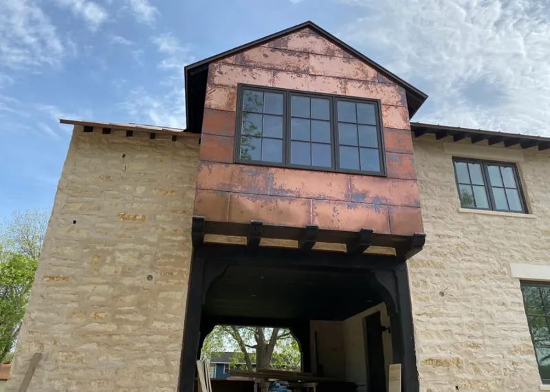 Copper metal panel facade on a stone building for Skylight Installation in Trussville
