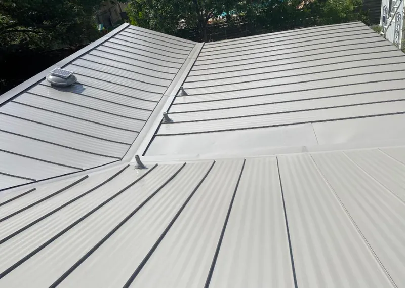 Solar attic fan installed on a metal roof for Roof Ventilation in Trussville